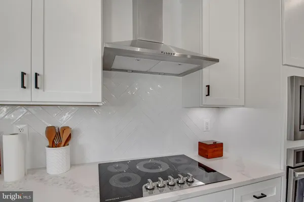 a white stove top oven sitting inside of a kitchen