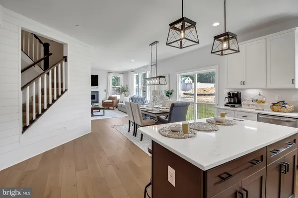 a kitchen with a table chairs refrigerator and cabinets