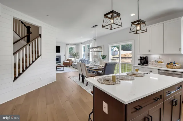 a kitchen with a table chairs refrigerator and cabinets