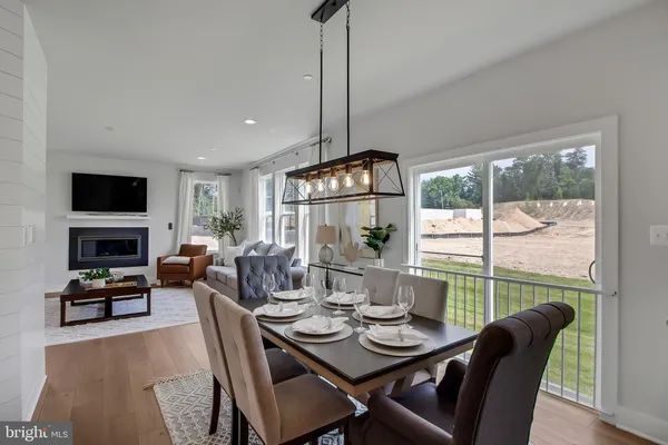 a dining room with furniture a chandelier and window