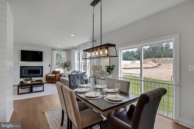 a dining room with furniture a chandelier and window