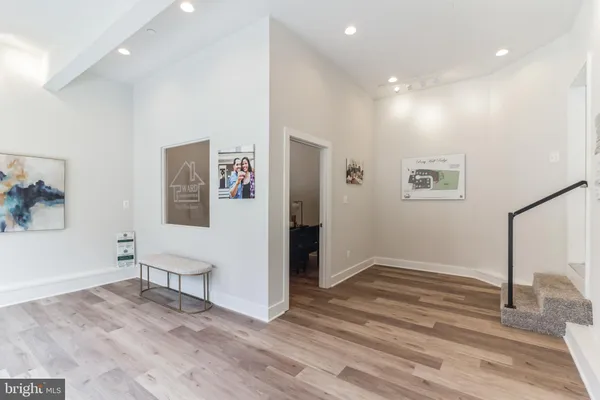 a view of a hallway with wooden floor and closet