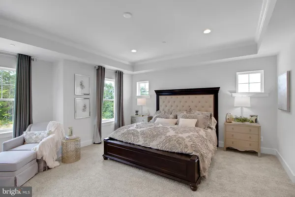 a spacious bedroom with a bed and a couch