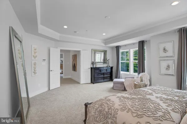 a bedroom with furniture and large windows
