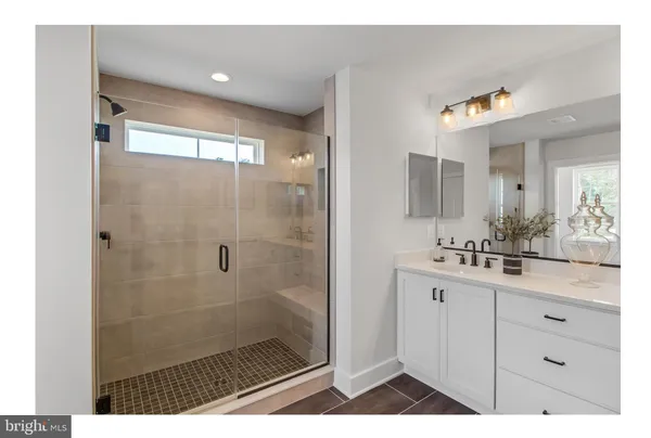 a bathroom with a shower a sink and a mirror
