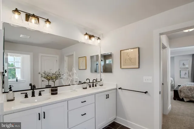 a bathroom with a double vanity sink mirror and shower