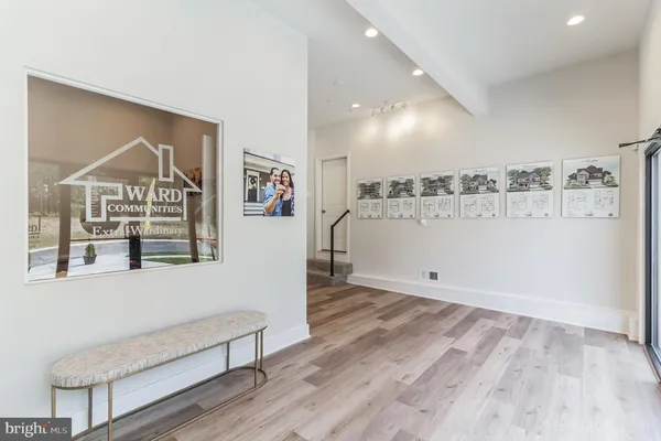 a view of a livingroom with wooden floor and windows