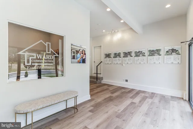 a view of a livingroom with wooden floor and windows