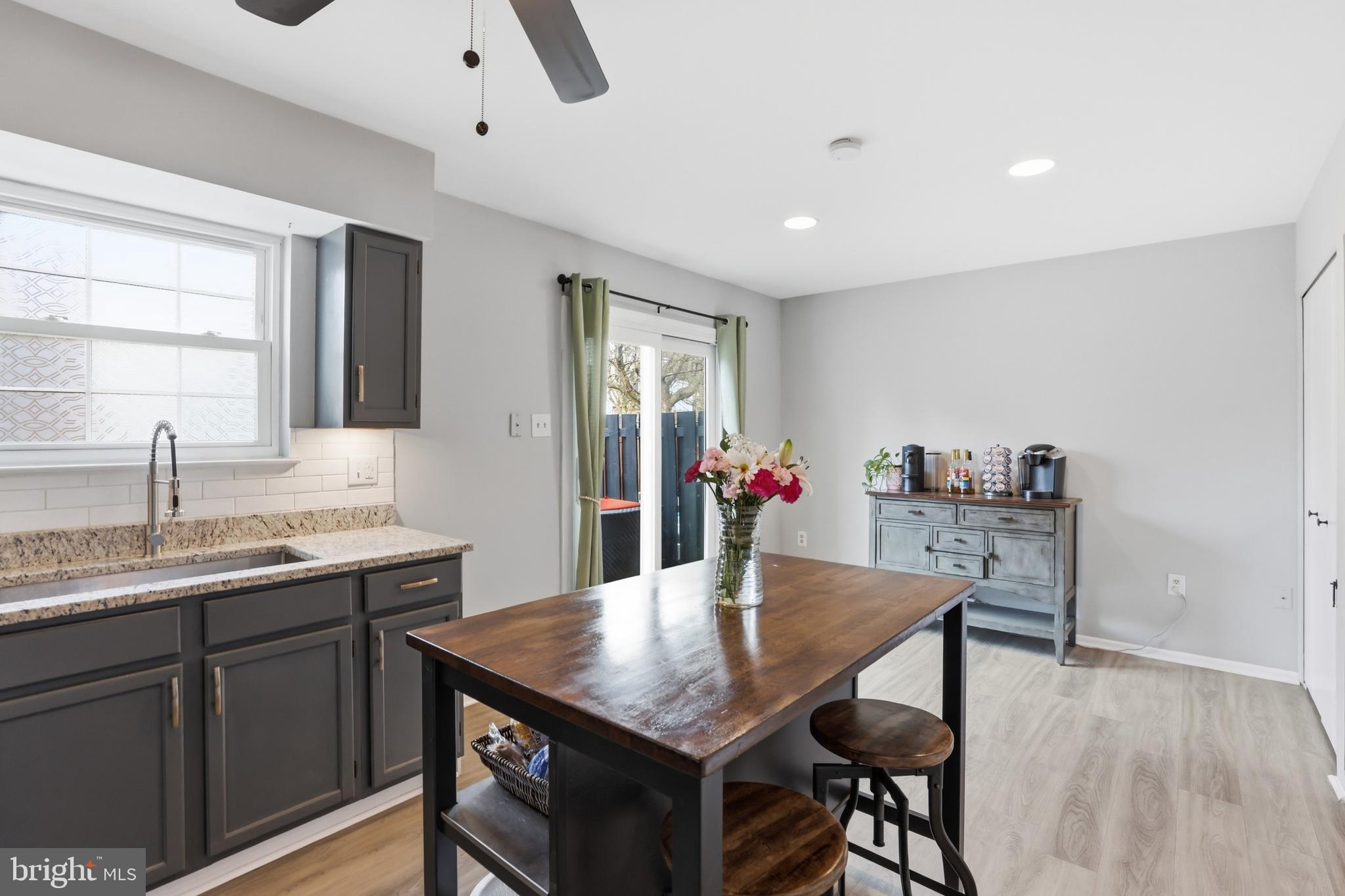 6844 Carnation Circle Frederick, MD 21703 - Photo 15 of 30 a view of a kitchen area with furniture and wooden floor