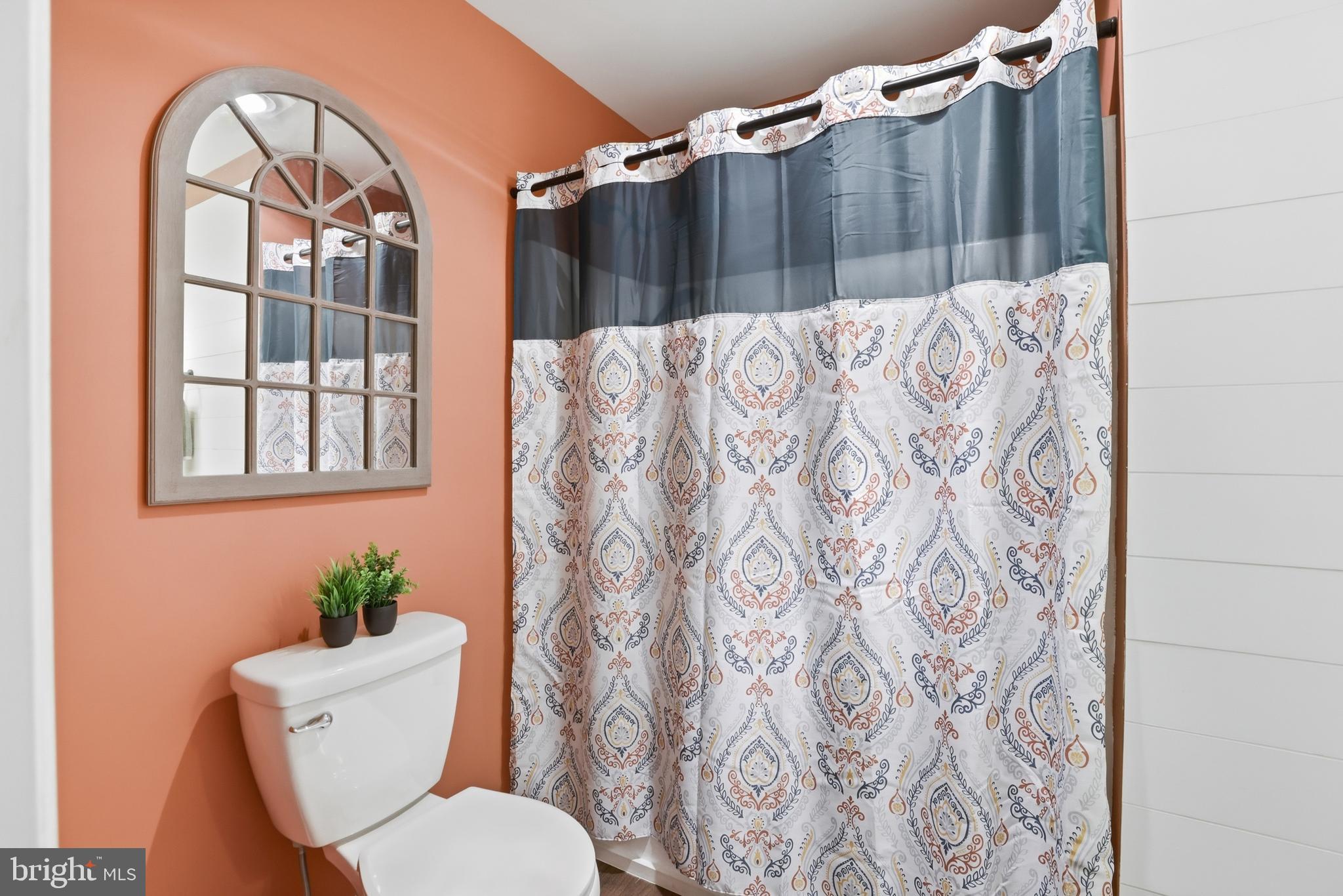 6844 Carnation Circle Frederick, MD 21703 - Photo 21 of 30 a bathroom with a toilet and a shower curtain