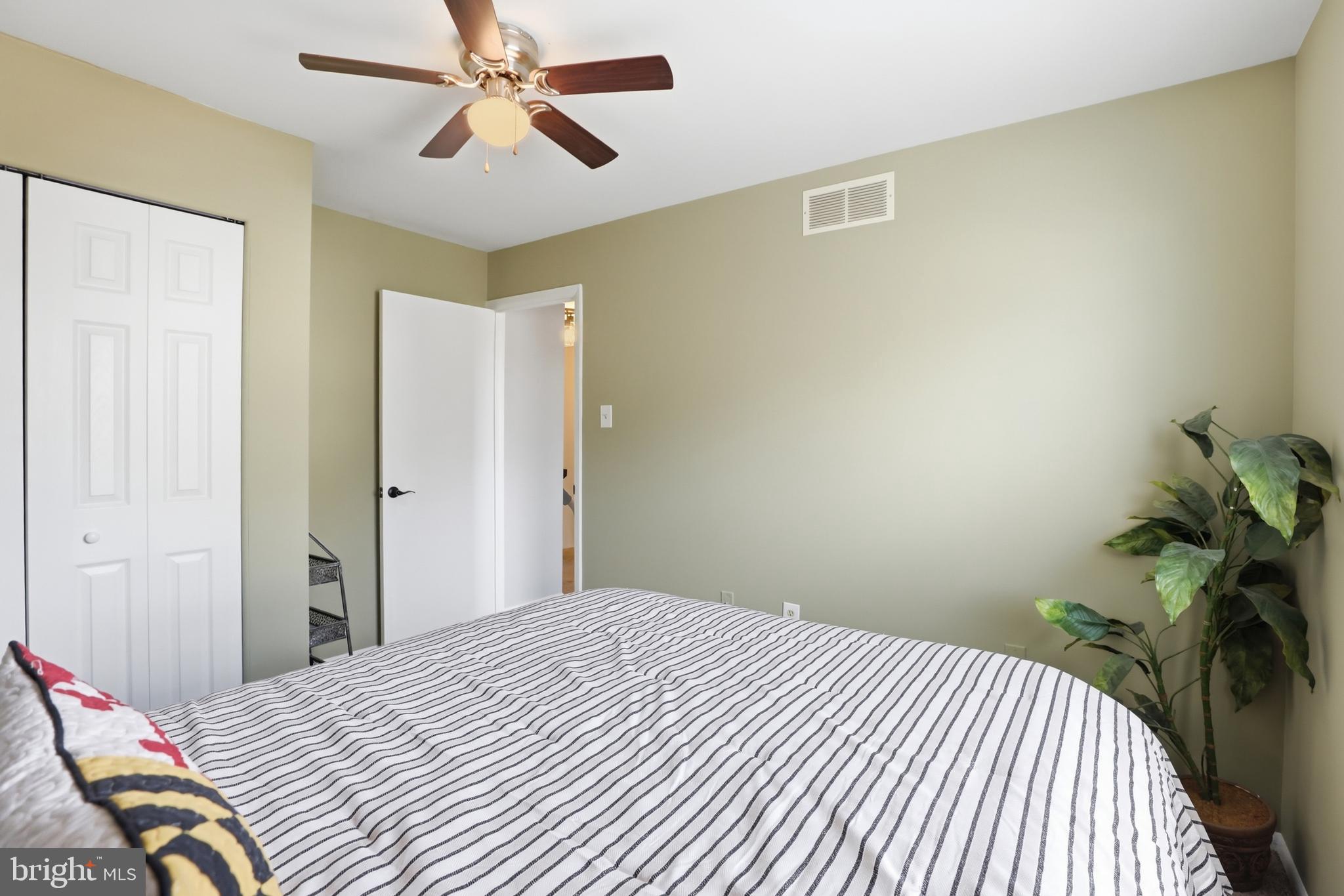 6844 Carnation Circle Frederick, MD 21703 - Photo 24 of 30 a bedroom with a bed and a chandelier