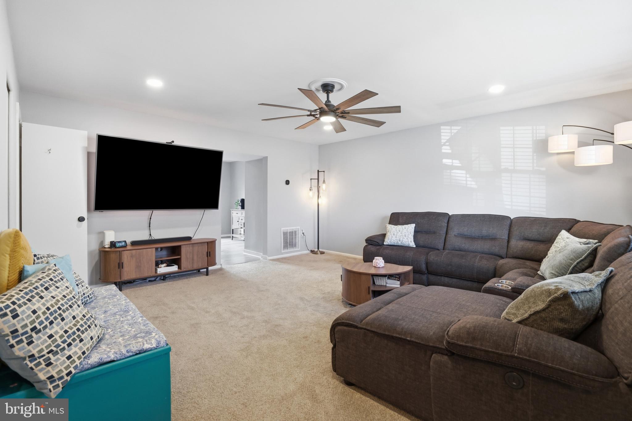 6844 Carnation Circle Frederick, MD 21703 - Photo 6 of 30 a living room with furniture and a flat screen tv