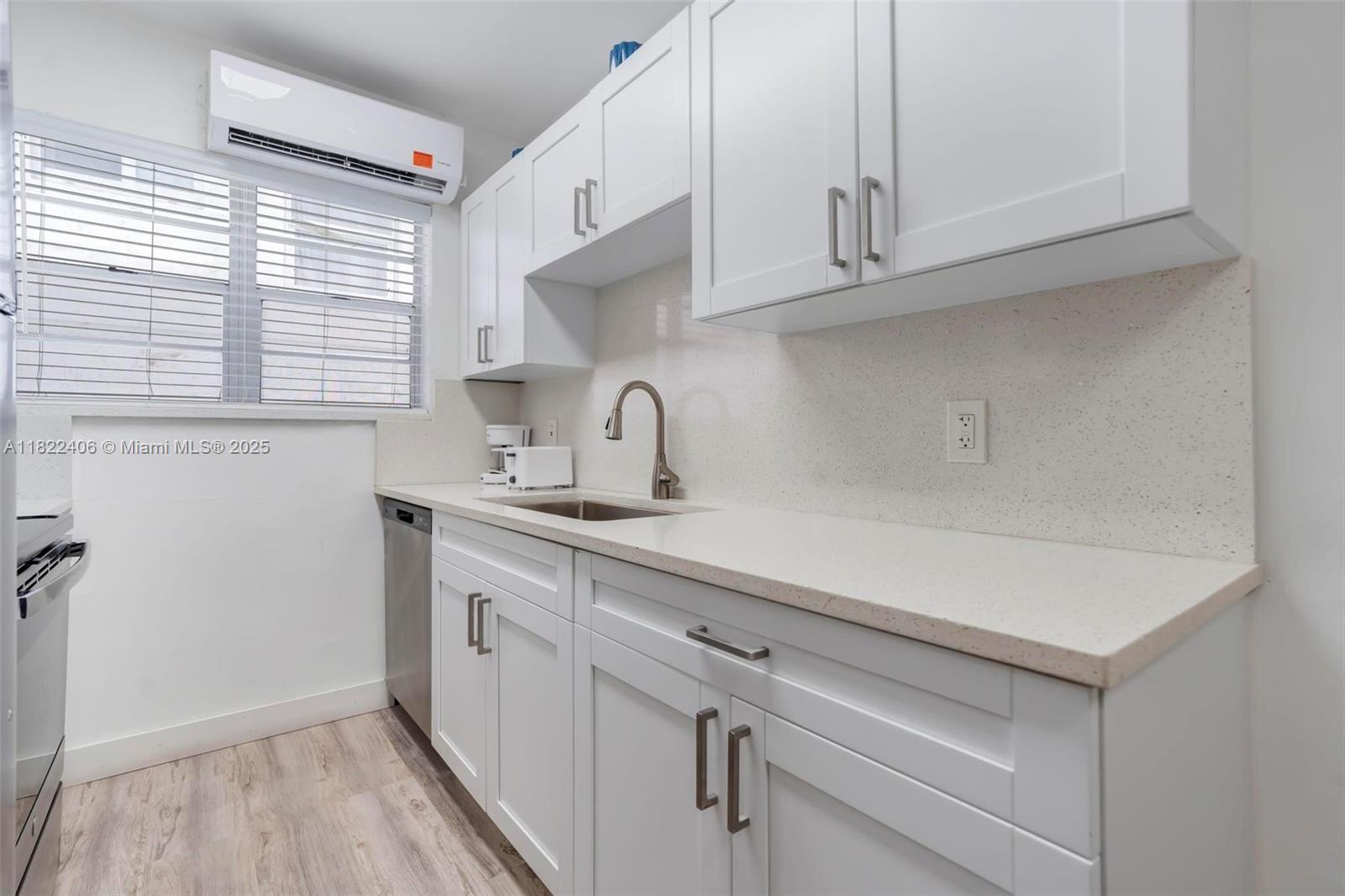4015 Indian Creek Drive, Unit 106 Miami Beach, FL 33140 - Photo 11 of 29 a kitchen with appliances cabinets and a sink