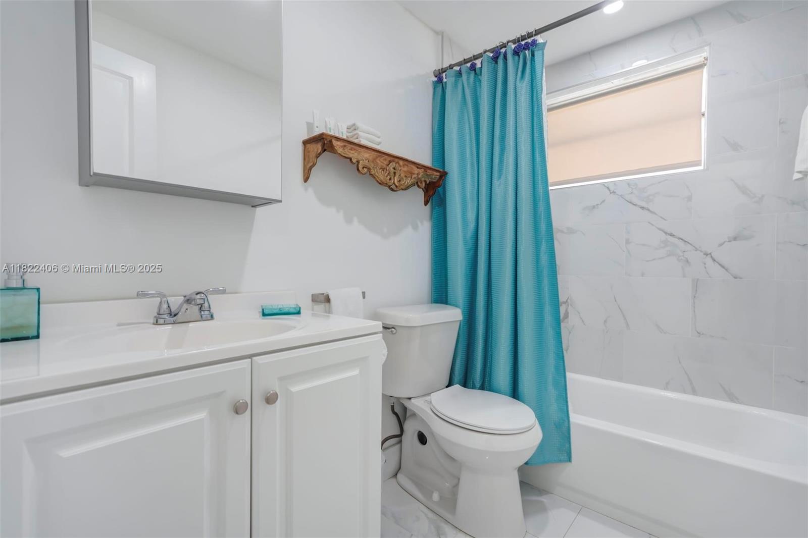 4015 Indian Creek Drive, Unit 106 Miami Beach, FL 33140 - Photo 13 of 29 a bathroom with a sink a toilet and shower