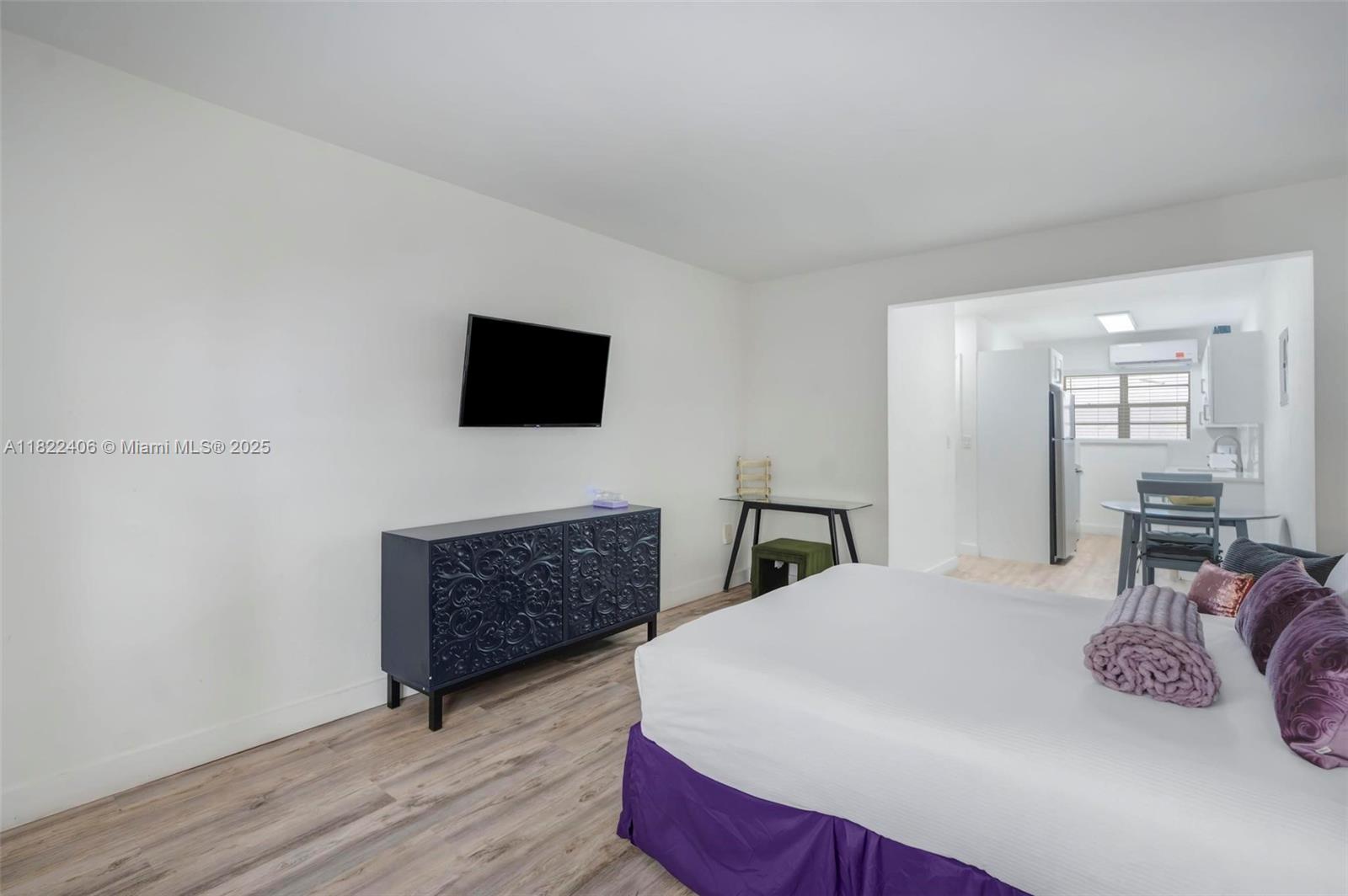 4015 Indian Creek Drive, Unit 106 Miami Beach, FL 33140 - Photo 14 of 29 a bedroom with a bed and a flat screen tv