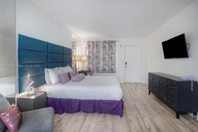 a bedroom with furniture and a chandelier