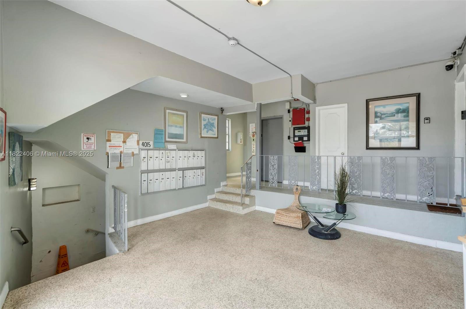 4015 Indian Creek Drive, Unit 106 Miami Beach, FL 33140 - Photo 16 of 29 a bedroom with furniture and a chandelier