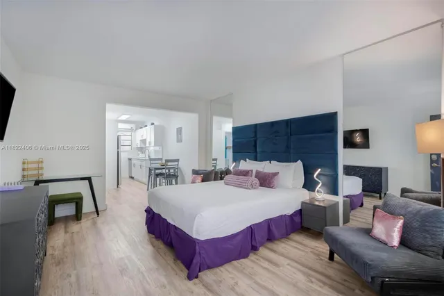 a bedroom with a bed and a flat screen television