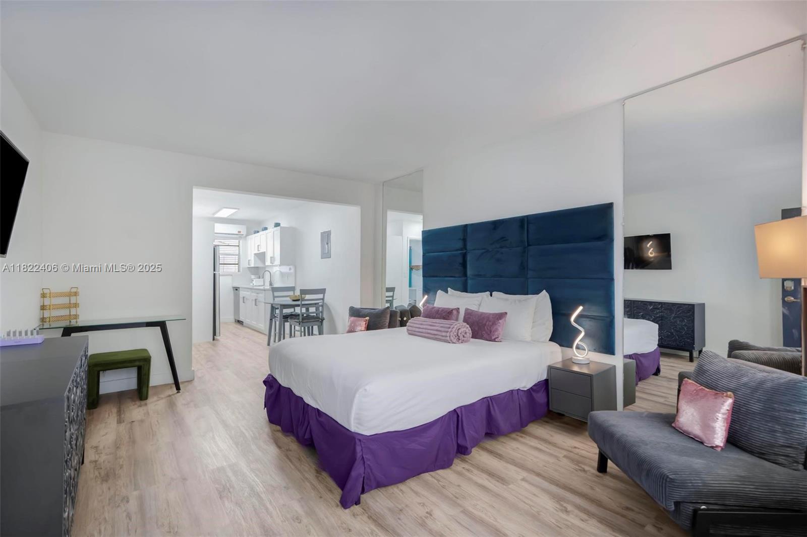 4015 Indian Creek Drive, Unit 106 Miami Beach, FL 33140 - Photo 4 of 29 a bedroom with a bed a table and chair