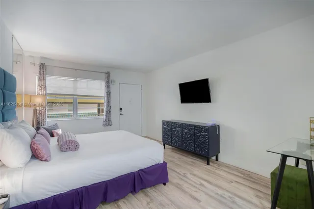 a bedroom with a large bed and a window