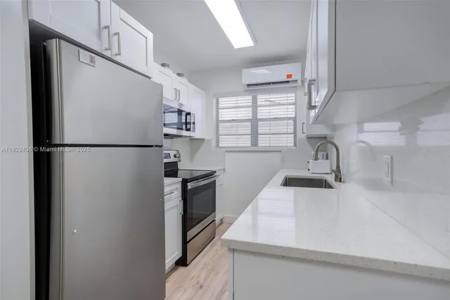 a kitchen with a stove microwave and sink