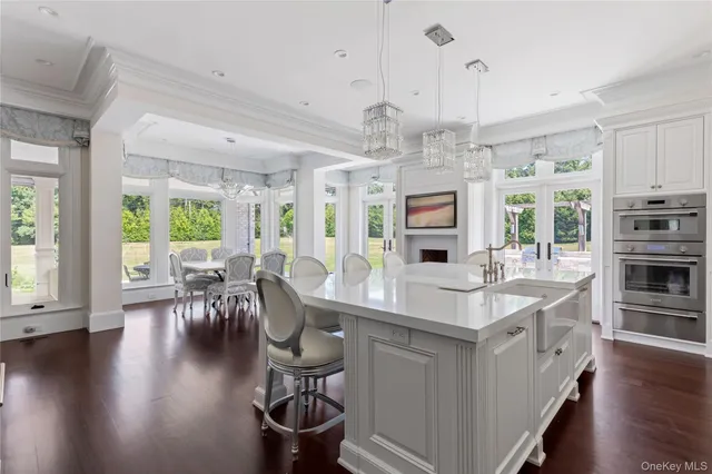 a large white kitchen with a large window