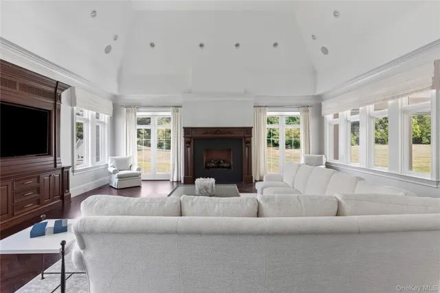 a living room with fireplace furniture and a large window