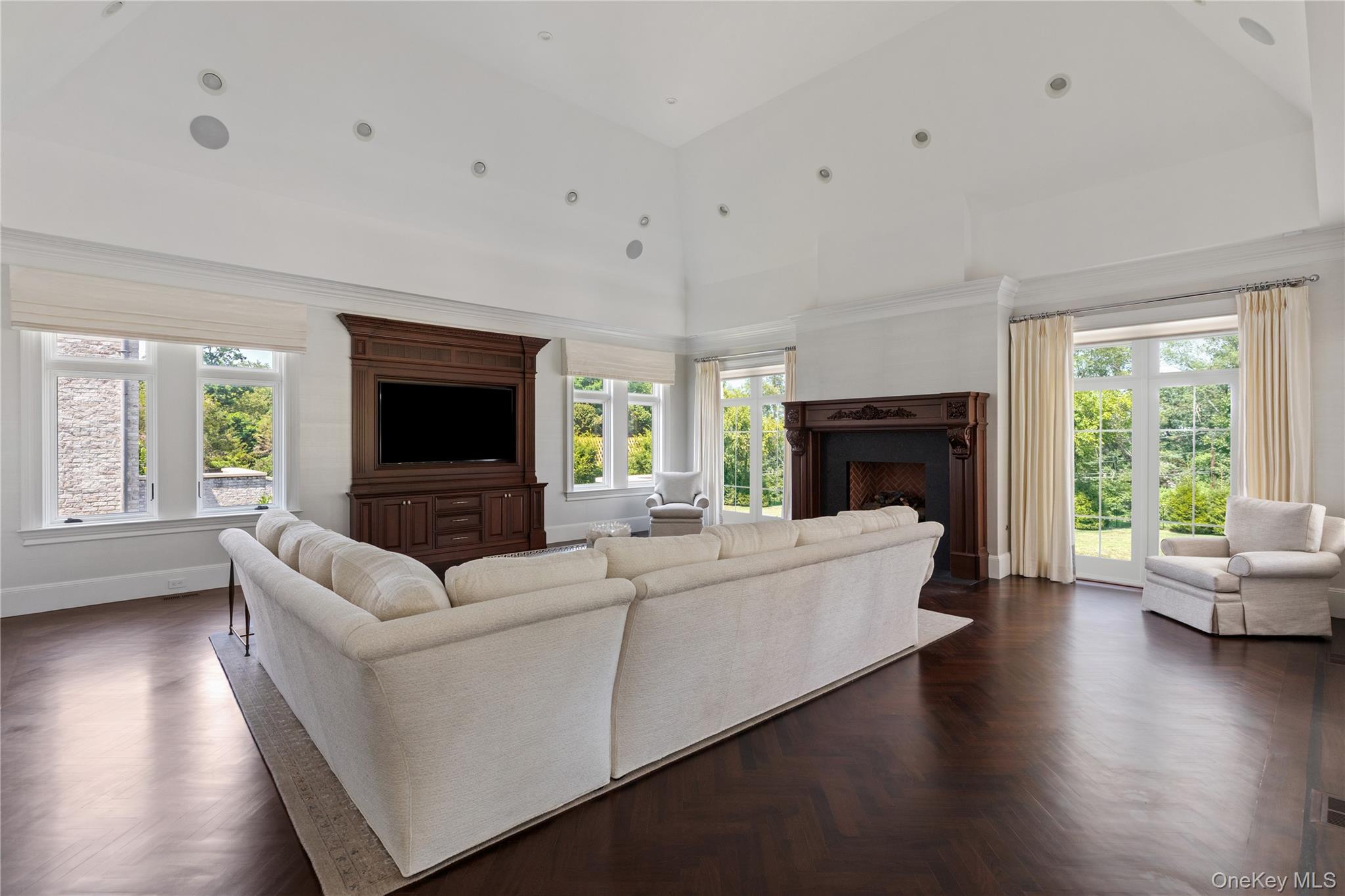 9 Hicks Lane Sands Point, NY 11050 - Photo 20 of 45 a living room with fireplace furniture and a large window