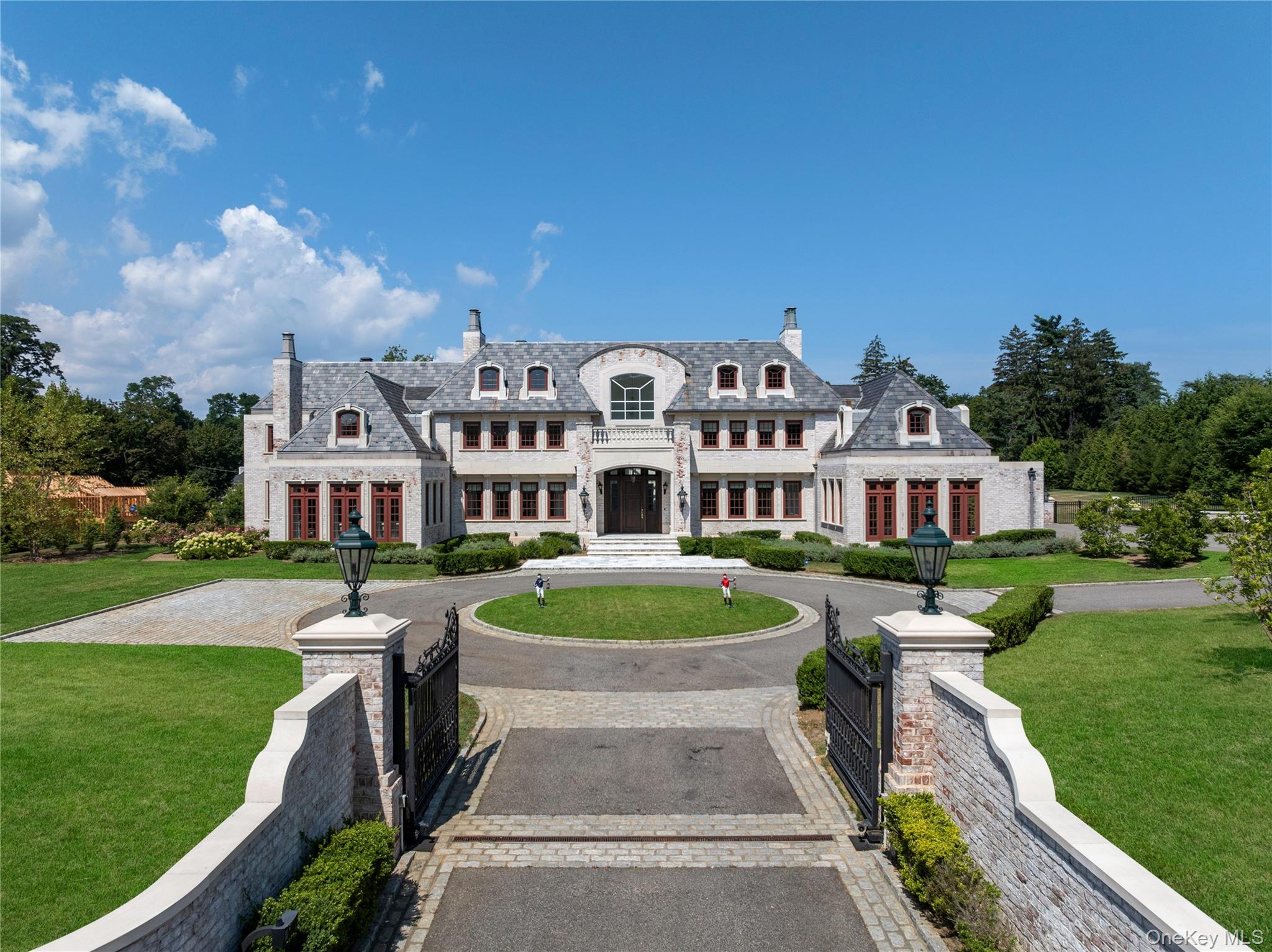 9 Hicks Lane Sands Point, NY 11050 - Photo 2 of 45 a front view of a house with garden