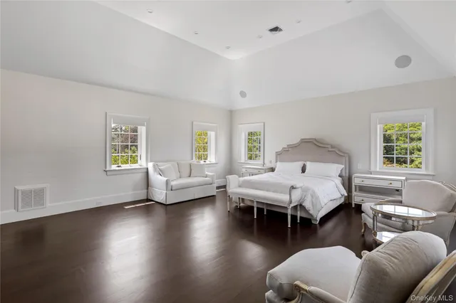 a spacious bathroom with a window a sink and shower