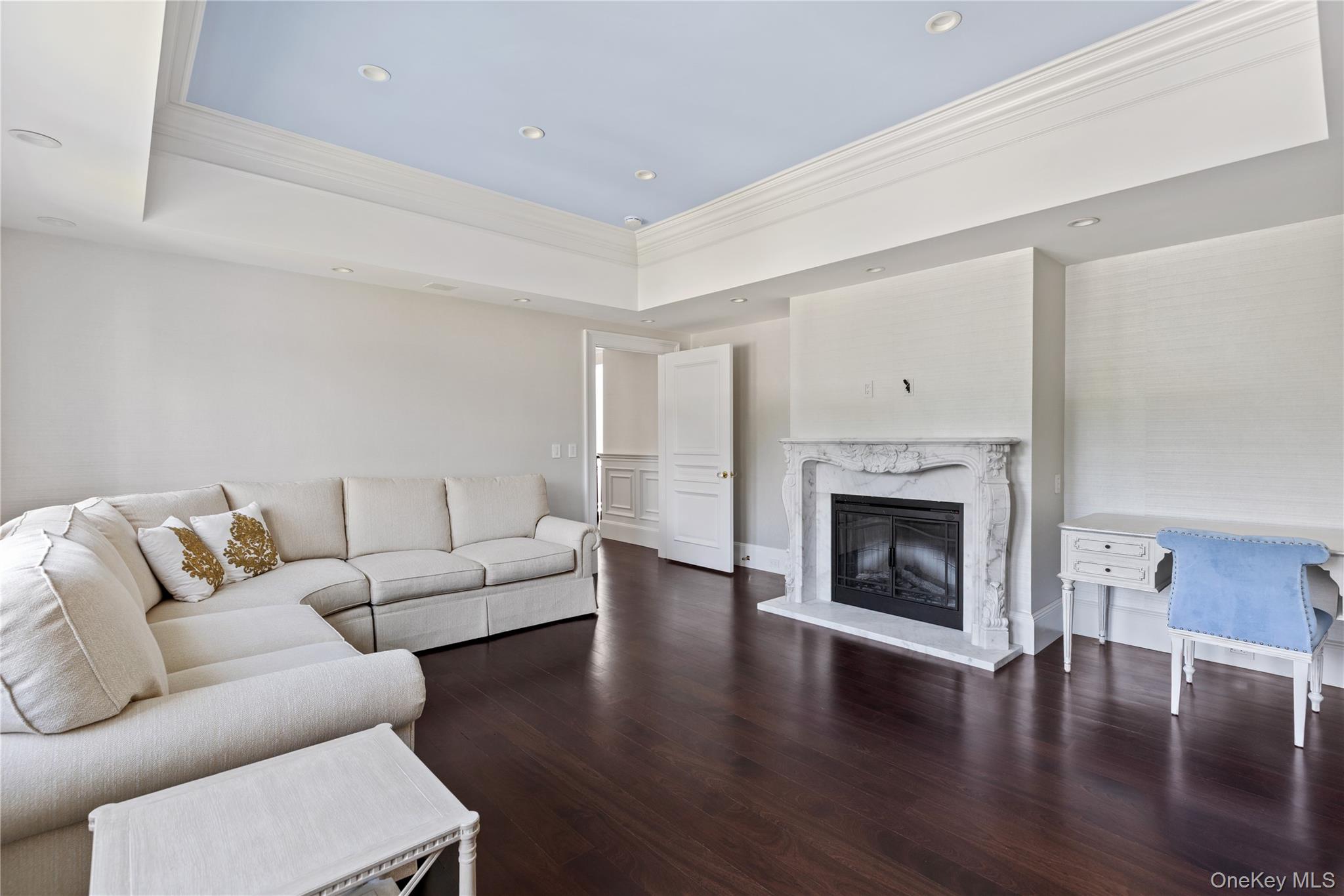 9 Hicks Lane Sands Point, NY 11050 - Photo 32 of 45 a living room with furniture a fireplace and wooden floor