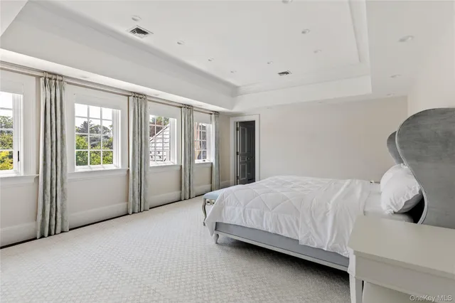 a spacious bedroom with a bed and a large window