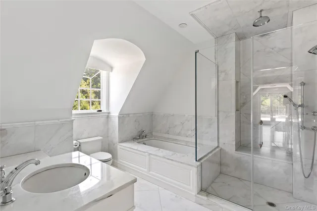 an empty room with windows and fireplace