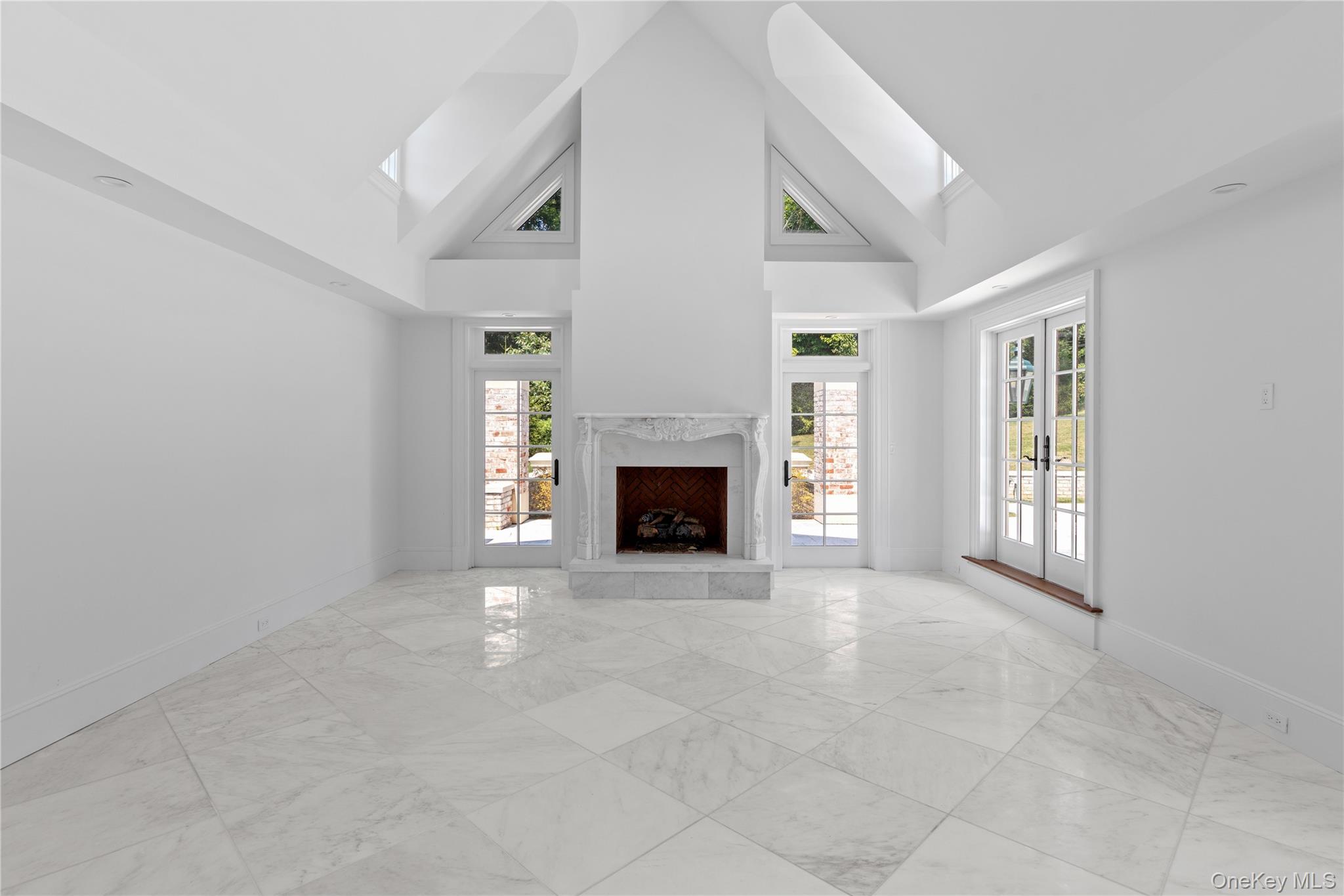 9 Hicks Lane Sands Point, NY 11050 - Photo 38 of 45 an empty room with windows and fireplace