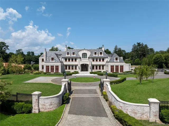 a view of a house with a big yard and large trees