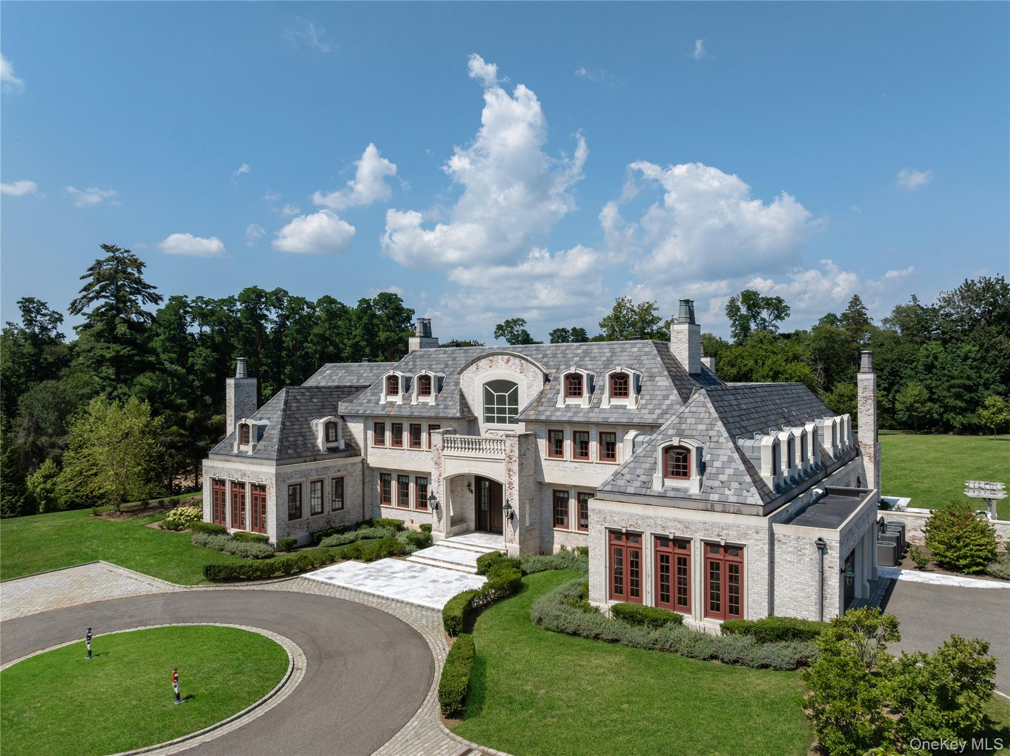 9 Hicks Lane Sands Point, NY 11050 - Photo 4 of 45 a front view of a house with a garden and trees
