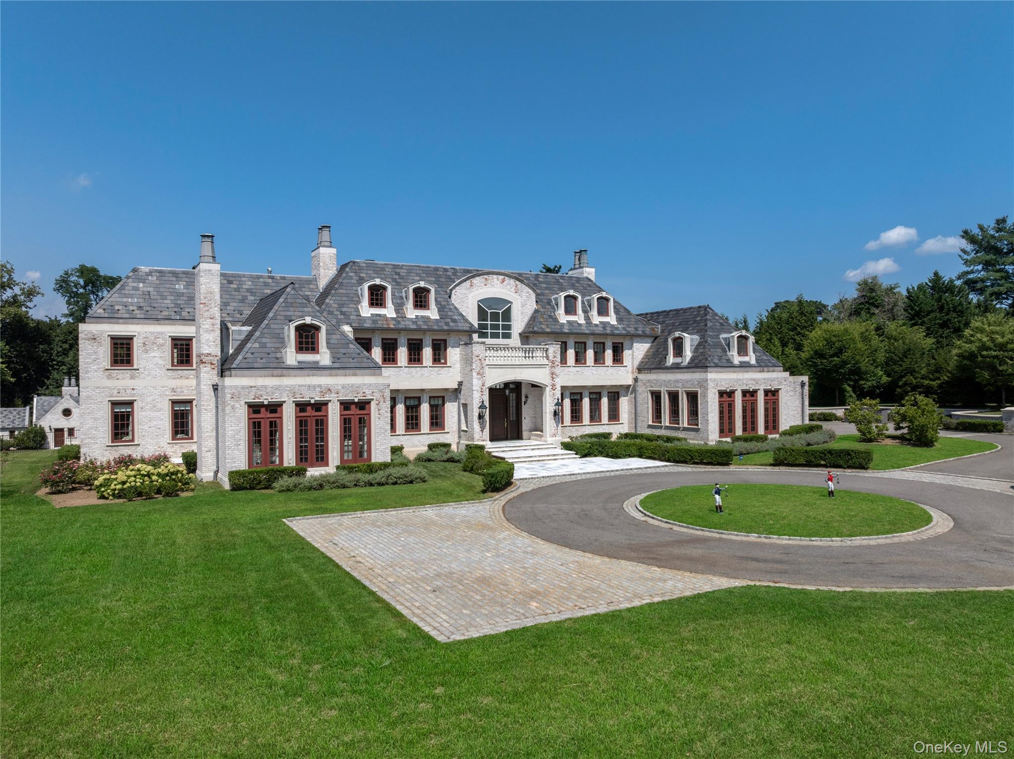9 Hicks Lane Sands Point, NY 11050 - Photo 41 of 45 a front view of a house with a garden