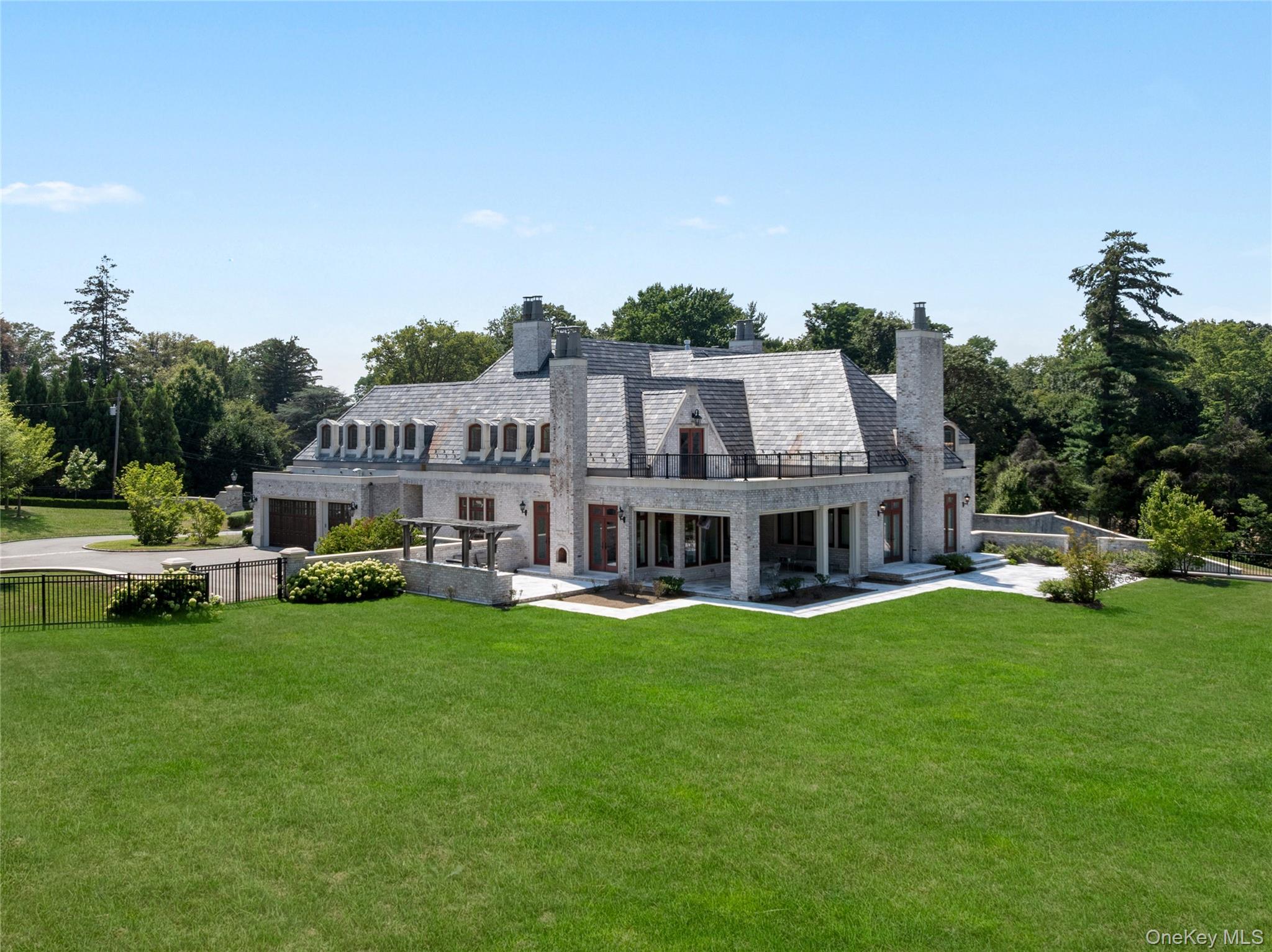 9 Hicks Lane Sands Point, NY 11050 - Photo 42 of 45 a view of a house with a big yard and large trees