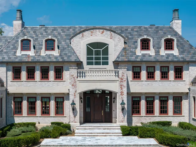 a front view of a house with large windows