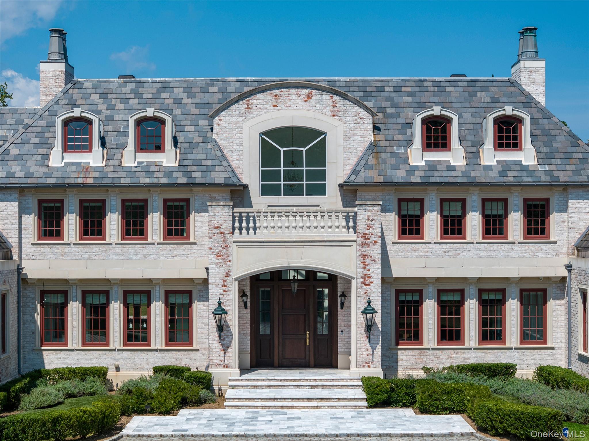 9 Hicks Lane Sands Point, NY 11050 - Photo 5 of 45 a front view of a house with large windows