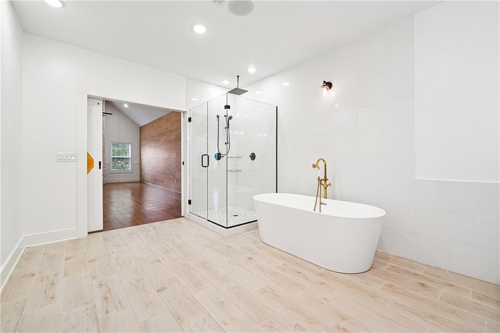 4603 Clarks Bridge Road Gainesville, GA 30506 - Photo 19 of 40 a white bath tub sitting in a bathroom