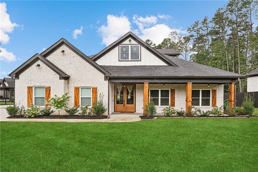 4603 Clarks Bridge Road Gainesville, GA 30506 - Photo 2 of 40 a front view of a house with a garden and plants
