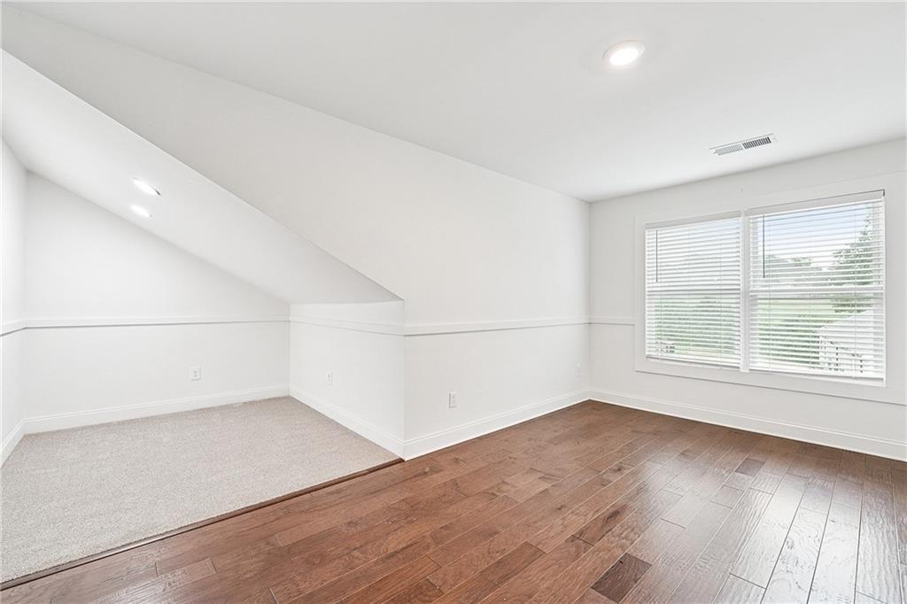 4603 Clarks Bridge Road Gainesville, GA 30506 - Photo 30 of 40 an empty room with wooden floor and windows