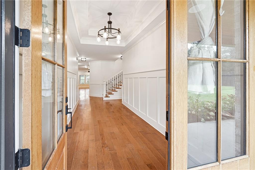 4603 Clarks Bridge Road Gainesville, GA 30506 - Photo 3 of 40 a view of a hallway with wooden floor and glass door