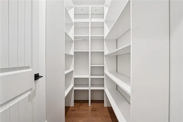 a view of walk in closet with empty racks