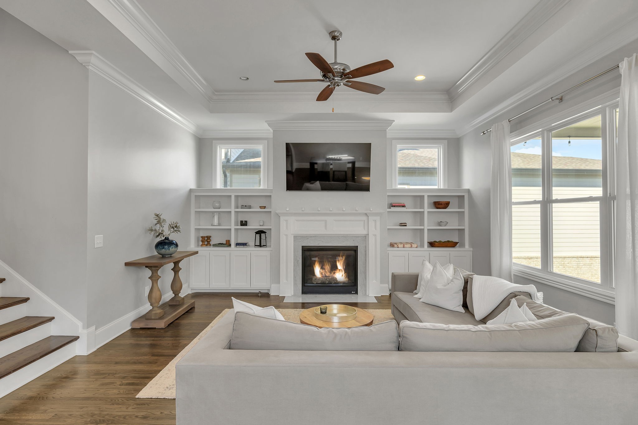 1606 Eliot Road Franklin, TN 37064 - Photo 18 of 49 a living room with furniture a flat screen tv and a fireplace