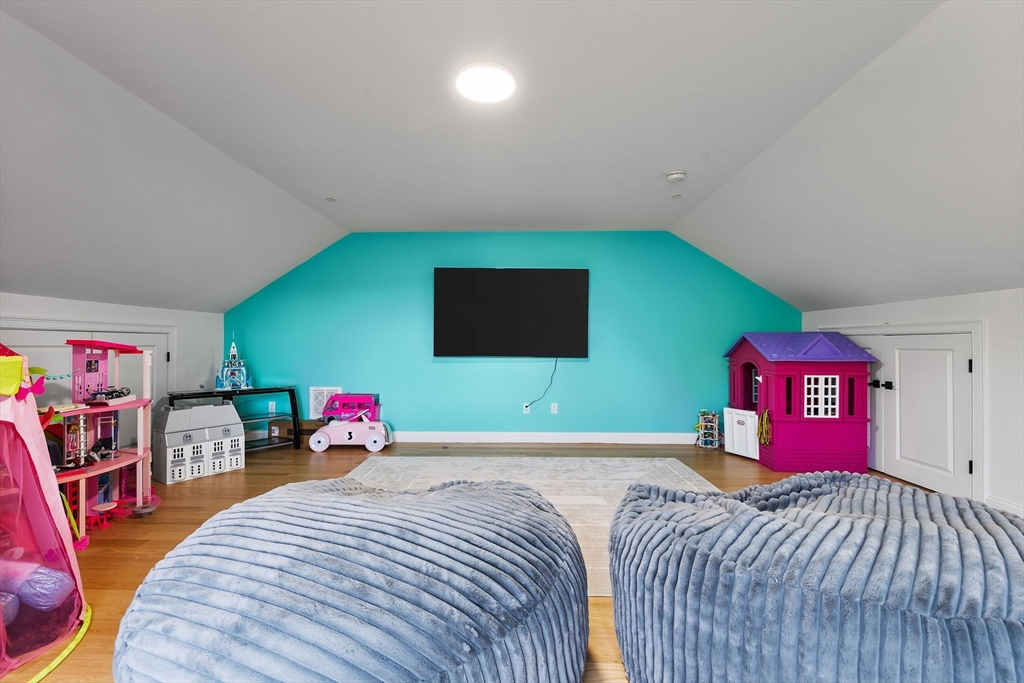 68 Prospect Street, Unit 14 Peabody, MA 01960 - Photo 18 of 29 a bedroom with a bed and a flat screen tv