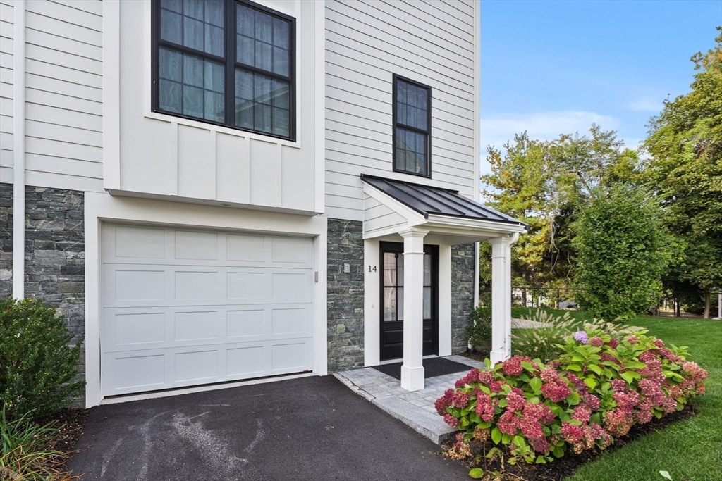 68 Prospect Street, Unit 14 Peabody, MA 01960 - Photo 21 of 29 a front view of a house with garden