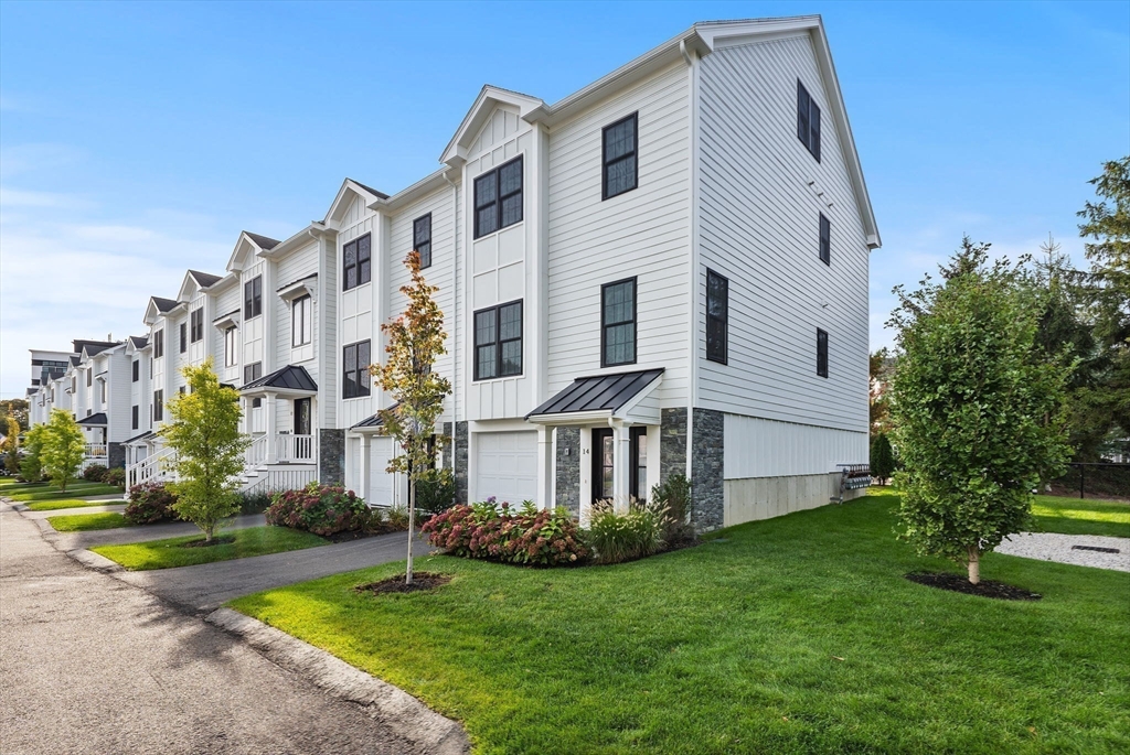 68 Prospect Street, Unit 14 Peabody, MA 01960 - Photo 24 of 29 a view of a white house with a yard and plants