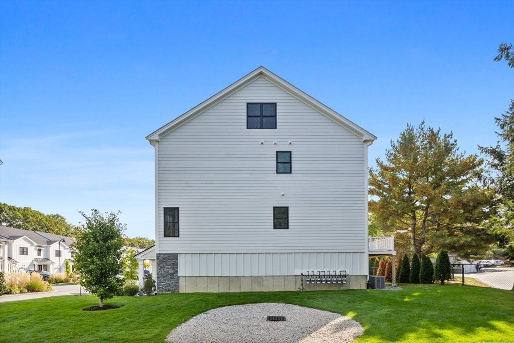 68 Prospect Street, Unit 14 Peabody, MA 01960 - Photo 26 of 29 a front view of a house with garden